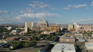 5.7K aerial stock footage of flying away from train tracks and the city skyline in Reno, Nevada Aerial Stock Footage | DX0001_005_006