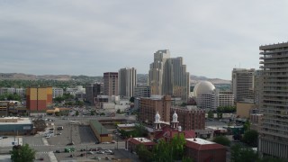 DX0001_006_025 - 5.7K aerial stock footage ascending to view the Saint Thomas Aquinas Cathedral and Silver Legacy Resort Casino in Reno, Nevada