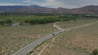 5.7K aerial stock footage of a black SUV driving on a desert road in Carson City, Nevada Aerial Stock Footage | DX0001_007_033