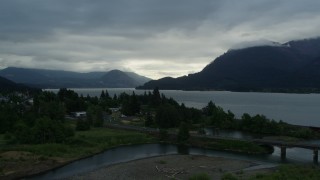 DX0001_008_001 - 5.7K aerial stock footage of the Columbia River and cloud-shrouded mountains at sunrise, Stevenson, Washington