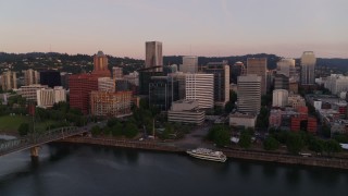 4K aerial stock footage flying by the downtown skyline, Hawthorne Bridge at sunrise, Downtown Portland, Oregon Aerial Stock Footage | DX0001_010_004