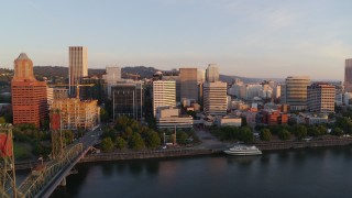 4K aerial stock footage flying away from Downtown and toward the Hawthorne Bridge at sunrise, Downtown Portland, Oregon Aerial Stock Footage | DX0001_010_017