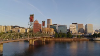 4K aerial stock footage flying over Hawthorne Bridge, approaching waterfront park and Downtown Portland, Oregon at sunrise Aerial Stock Footage | DX0001_010_023