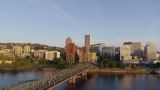 4K aerial stock footage flying away from downtown buildings and over the Hawthorne Bridge, Downtown Portland, Oregon Aerial Stock Footage | DX0001_010_024