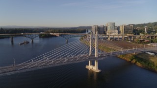 DX0001_010_029 - 4K aerial stock footage flying away from Tilikum Crossing, Bridge of the People, spanning Willamette River, South Portland, Oregon