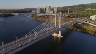 4K aerial stock footage flying by Tilikum Crossing, Bridge of the People, spanning Willamette River, South Portland, Oregon Aerial Stock Footage | DX0001_010_030