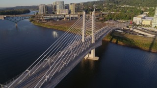 DX0001_010_031 - 4K aerial stock footage orbiting Tilikum Crossing, Bridge of the People, revealing shoreline, South Portland, Oregon