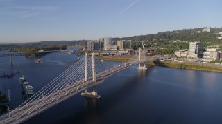 4K aerial stock footage flying away from Tilikum Crossing, descending on the Willamette River, South Portland, Oregon Aerial Stock Footage | DX0001_010_042