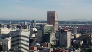 5.7K aerial stock footage flying by U.S. Bancorp Tower, skyscrapers on a partly cloudy day, Downtown Portland, Oregon Aerial Stock Footage | DX0001_011_002