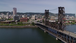 5.7K aerial stock footage flying by Steel Bridge and revealing waterfront apartment buildings, Downtown Portland, Oregon Aerial Stock Footage | DX0001_012_001