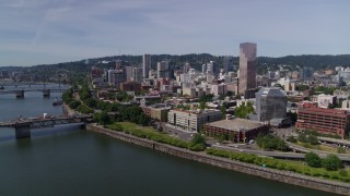 5.7K aerial stock footage fly over Willamette River, to approach Downtown Portland, Oregon Aerial Stock Footage | DX0001_012_011