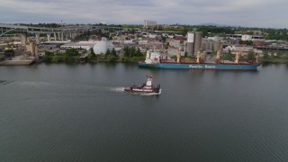 5.7K aerial stock footage of tracking tugboat sailing the Willamette River by North Portland, Oregon Aerial Stock Footage | DX0001_013_006