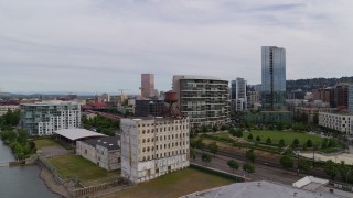 5.7K aerial stock footage descending toward an old factory near a park, sunset, Downtown Portland, Oregon Aerial Stock Footage | DX0001_013_012