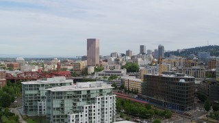 DX0001_013_028 - 5.7K aerial stock footage of fly away from downtown to reveal condominiums and factory water tower, sunset, Downtown Portland, Oregon