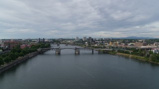 5.7K aerial stock footage reverse over Hawthorne Bridge from Morrison Bridge spanning the Willamette, sunset, Southeast Portland, Oregon Aerial Stock Footage | DX0001_014_002