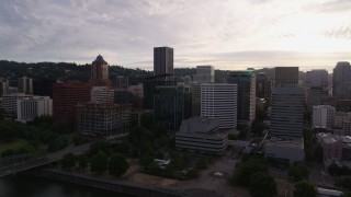 5.7K aerial stock footage of approaching office buildings near the river at sunset, Downtown Portland, Oregon Aerial Stock Footage | DX0001_014_004