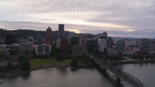 5.7K aerial stock footage flying over the Hawthorne Bridge with a view of the Downtown Portland skyline at sunset, Oregon Aerial Stock Footage | DX0001_014_014