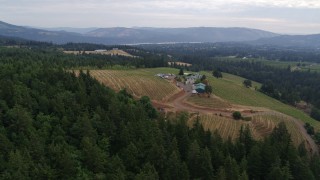 5.7K aerial stock footage of a wide angle orbit of winery with mountains in background, Hood River, Oregon Aerial Stock Footage | DX0001_015_004