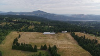 5.7K aerial stock footage approaching a farm and fields in Hood River, Oregon Aerial Stock Footage | DX0001_015_014