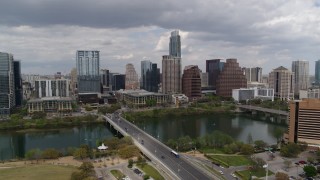 5.7K aerial stock footage descend near First Street Bridge and Lady Bird Lake with view of skyline, Downtown Austin, Texas Aerial Stock Footage | DX0002_102_011