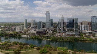 5.7K aerial stock footage of a reverse view of city skyscrapers across Lady Bird Lake, Downtown Austin, Texas Aerial Stock Footage | DX0002_102_013