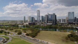 5.7K aerial stock footage of a view of city skyline across Lady Bird Lake during descent, Downtown Austin, Texas Aerial Stock Footage | DX0002_102_014