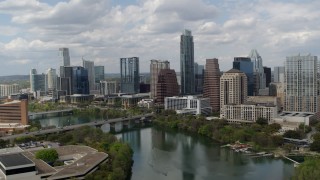 5.7K aerial stock footage approach the city skyline from Lady Bird Lake and ascend, Downtown Austin, Texas Aerial Stock Footage | DX0002_102_018