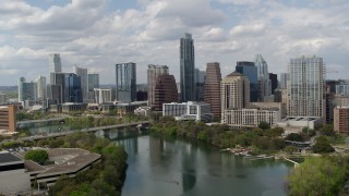 5.7K aerial stock footage of flying away from the city skyline from Lady Bird Lake, Downtown Austin, Texas Aerial Stock Footage | DX0002_102_019