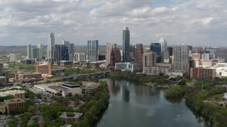 5.7K aerial stock footage slowly fly away from the city skyline while passing over Lady Bird Lake, Downtown Austin, Texas Aerial Stock Footage | DX0002_102_023