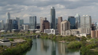 5.7K aerial stock footage of towering skyscrapers in Downtown Austin, Texas seen while ascending over Lady Bird Lake Aerial Stock Footage | DX0002_103_007