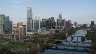 5.7K aerial stock footage approach Lady Bird Lake with view of bridges and skyscrapers, Downtown Austin, Texas Aerial Stock Footage | DX0002_104_005