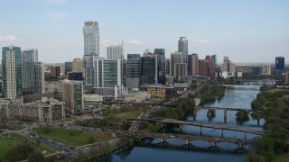 5.7K aerial stock footage reverse view of tall skyscrapers and bridges over Lady Bird Lake, Downtown Austin, Texas Aerial Stock Footage | DX0002_104_008