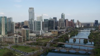 5.7K aerial stock footage fly over Lady Bird Lake to approach towering skyscrapers, Downtown Austin, Texas Aerial Stock Footage | DX0002_104_009