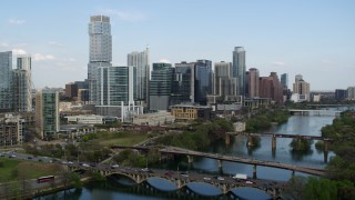 5.7K aerial stock footage fly away from towering skyscrapers and bridges over Lady Bird Lake, Downtown Austin, Texas Aerial Stock Footage | DX0002_104_013