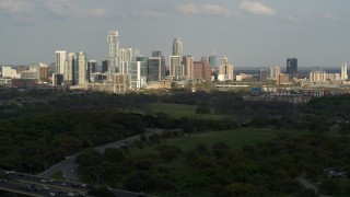 5.7K aerial stock footage of a wide view of city's towering skyline seen from green parks, Downtown Austin, Texas Aerial Stock Footage | DX0002_104_021