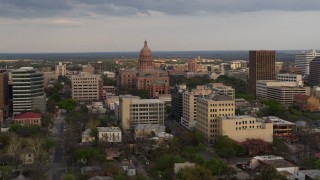 5.7K aerial stock footage of flying by the Texas State Capitol building at sunset in Downtown Austin, Texas Aerial Stock Footage | DX0002_104_033