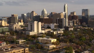 5.7K aerial stock footage of a courthouse and office buildings near skyscrapers at sunset in Downtown Austin, Texas Aerial Stock Footage | DX0002_104_038