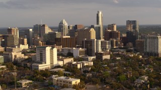 5.7K aerial stock footage a slow approach to a courthouse and office buildings near skyscrapers at sunset in Downtown Austin, Texas Aerial Stock Footage | DX0002_104_041