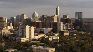 5.7K aerial stock footage ascend and approach courthouse, office buildings near skyscrapers at sunset in Downtown Austin, Texas Aerial Stock Footage | DX0002_104_044