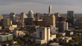 DX0002_104_045 - 5.7K aerial stock footage passing courthouse near office buildings and skyscrapers at sunset in Downtown Austin, Texas