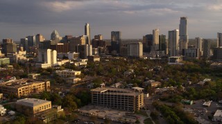 5.7K aerial stock footage of flying away from skyscrapers and office buildings at sunset in Downtown Austin, Texas Aerial Stock Footage | DX0002_105_003