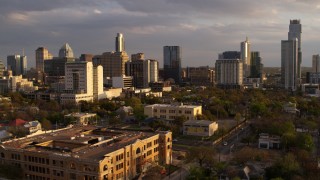 5.7K aerial stock footage of office buildings and skyscrapers, fly low near courthouse at sunset in Downtown Austin, Texas Aerial Stock Footage | DX0002_105_010