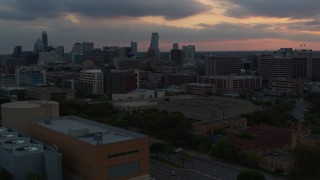 5.7K aerial stock footage office buildings and capitol dome at sunset, skyscrapers in background in Downtown Austin, Texas Aerial Stock Footage | DX0002_105_020