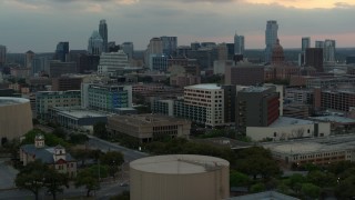 5.7K aerial stock footage ascend for view of hospital, skyscrapers and capitol dome at sunset in Downtown Austin, Texas Aerial Stock Footage | DX0002_105_021