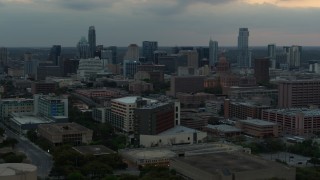 5.7K aerial stock footage of office buildings and capitol dome at sunset, skyscrapers in distance in Downtown Austin, Texas Aerial Stock Footage | DX0002_105_023