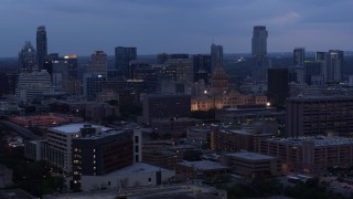 5.7K aerial stock footage a view of office buildings around capitol at twilight, skyscrapers in background in Downtown Austin, Texas Aerial Stock Footage | DX0002_105_041