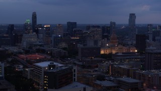 5.7K aerial stock footage of passing by office buildings, capitol and skyscrapers at twilight in Downtown Austin, Texas Aerial Stock Footage | DX0002_105_045