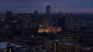 DX0002_105_053 - 5.7K aerial stock footage ascend near office buildings with view of state capitol at twilight in Downtown Austin, Texas