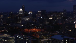 DX0002_106_001 - 5.7K aerial stock footage approach office buildings and skyscrapers at night in Downtown Austin, Texas