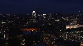 5.7K aerial stock footage of passing by office buildings, skyscrapers and capitol at night in Downtown Austin, Texas Aerial Stock Footage | DX0002_106_004